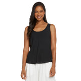 This is a product photo of a woman with long, dark, straight hair, smiling directly at the camera. She is wearing a plain black tank top with a modest scoop neck, paired with wide-legged white pants.
