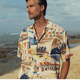 Man wearing a colorful patterned shirt on a beach