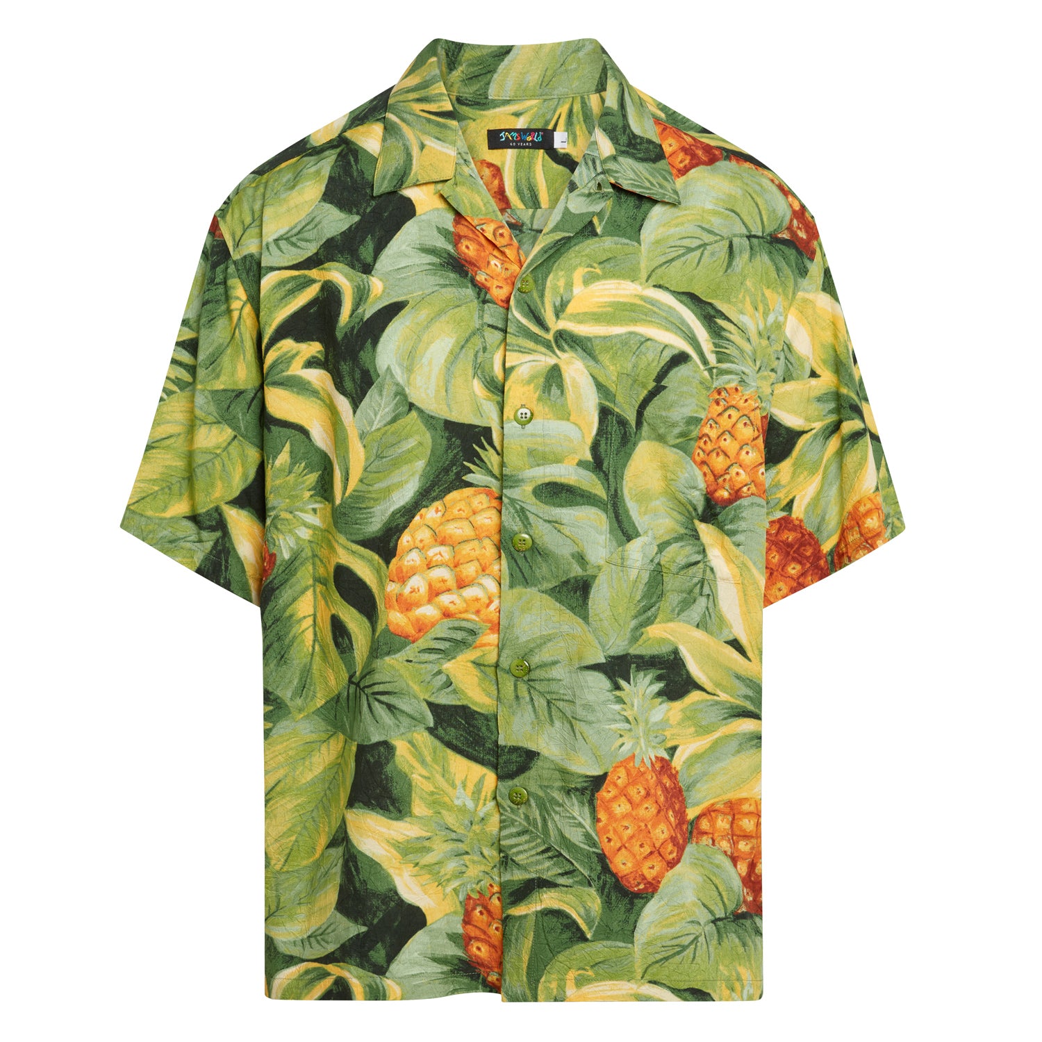 This is a product photo of the same short-sleeved Hawaiian shirt displayed flat against a white background. The pattern consists of vivid orange pineapples interspersed with dense, lush tropical foliage in various shades of dark green, lime green, and yellow-green.