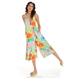 Woman wearing a colorful floral jumpsuit on a white background