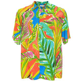 This is a flat studio shot of a short-sleeved men's collared shirt set against a white background. The shirt features an extremely vibrant, abstract tropical print dominated by bright colors like fuchsia, lime green, electric blue, and orange in a large-scale leaf pattern.
