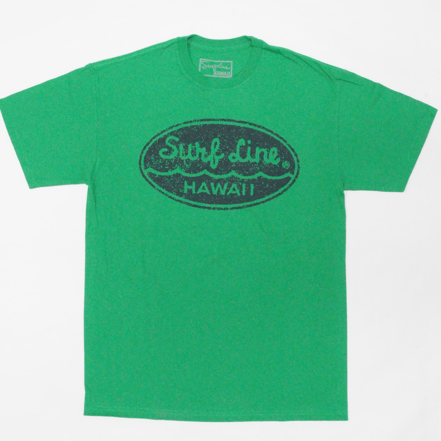 Front of heather green short-sleeved cotton T-shirt featuring a large distressed dark blue oval logo centered on the chest. Inside the oval, a heather green Surf Line is written in a cursive script across the top half, with a heather green wave line beneath, followed by a heather green HAWAII in capital letters at the bottom.
