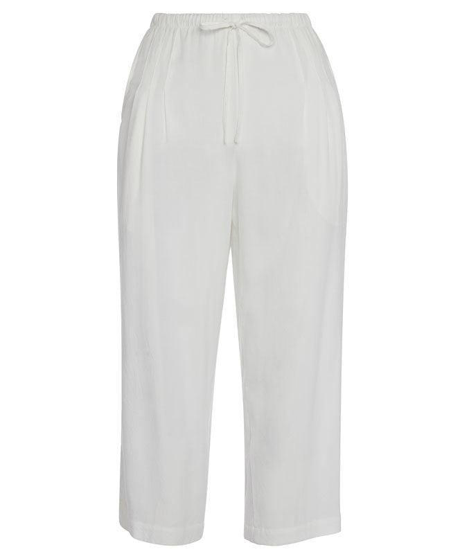 This is a product photo of a pair of plain white cropped pants shown flat against a white background. They have a relaxed fit, an elastic waistband, and a visible drawstring tie.