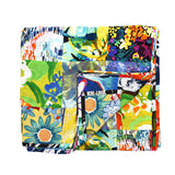This is a flat, square-folded quilt or blanket featuring a vibrant, multicolored patchwork design with floral and abstract patterns in bright shades of green, yellow, blue, and red.
