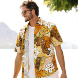 This image features the same man from the previous image, now smiling and looking to the side, wearing the yellow and brown tropical shirt unbuttoned over a white t-shirt and white shorts. He is standing outdoors with sunglasses on, and a bright, slightly blurred natural background is visible behind him.