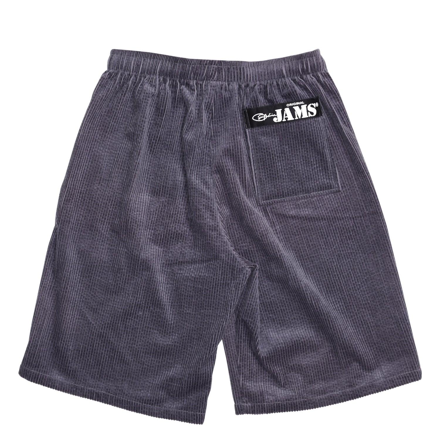 This image shows the back of the same gray corduroy shorts, laid flat against a white background. A single back pocket is visible, along with the "ORIGINAL JAMS" black patch on the upper right side.