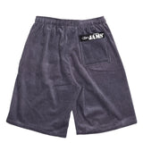 This image shows the back of the same gray corduroy shorts, laid flat against a white background. A single back pocket is visible, along with the "ORIGINAL JAMS" black patch on the upper right side.