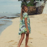 foliage dress, shortsleeve, short dress, on model walking on the beach.