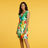 Woman wearing a colorful floral dress on a yellow background