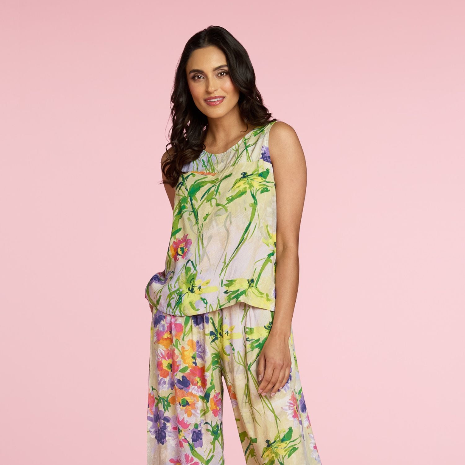 Woman wearing a floral dress on a pink background