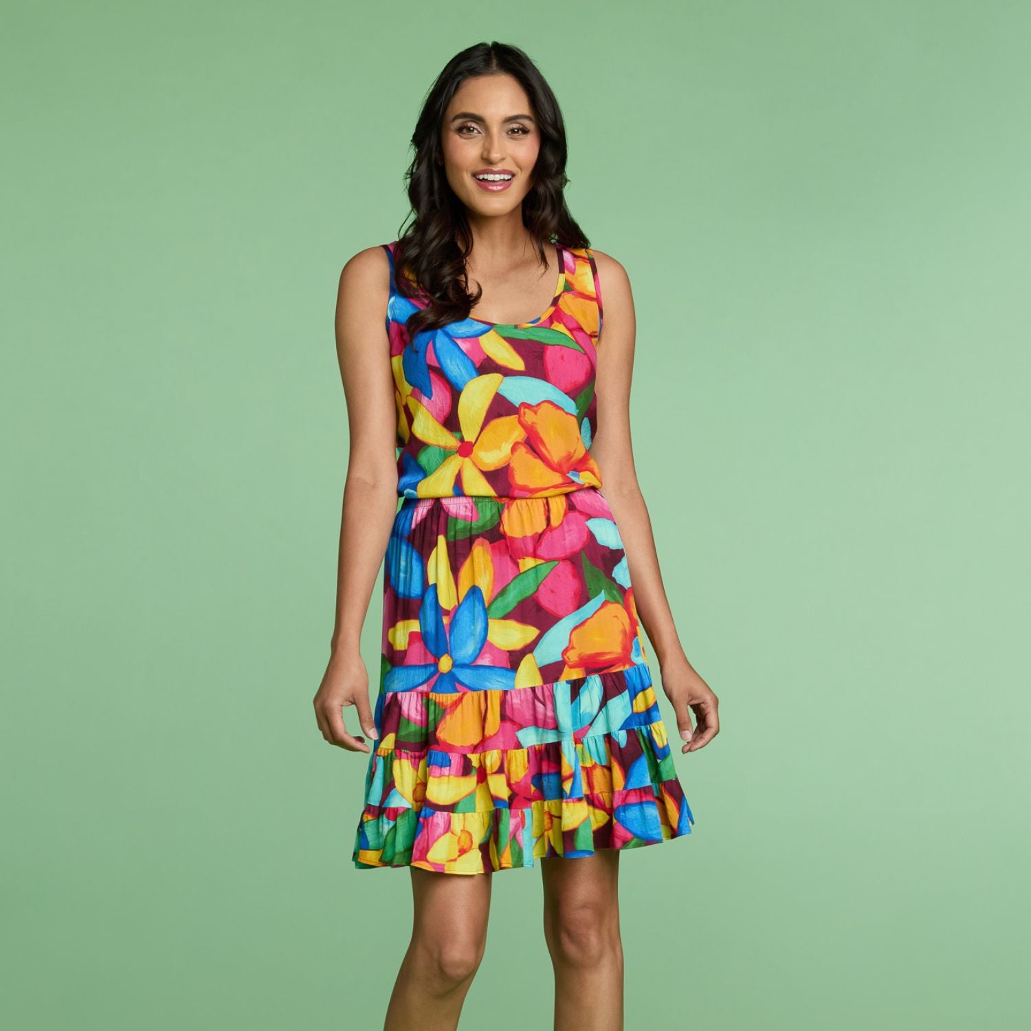 Woman wearing a colorful dress against a green background