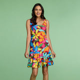 Woman wearing a colorful dress against a green background