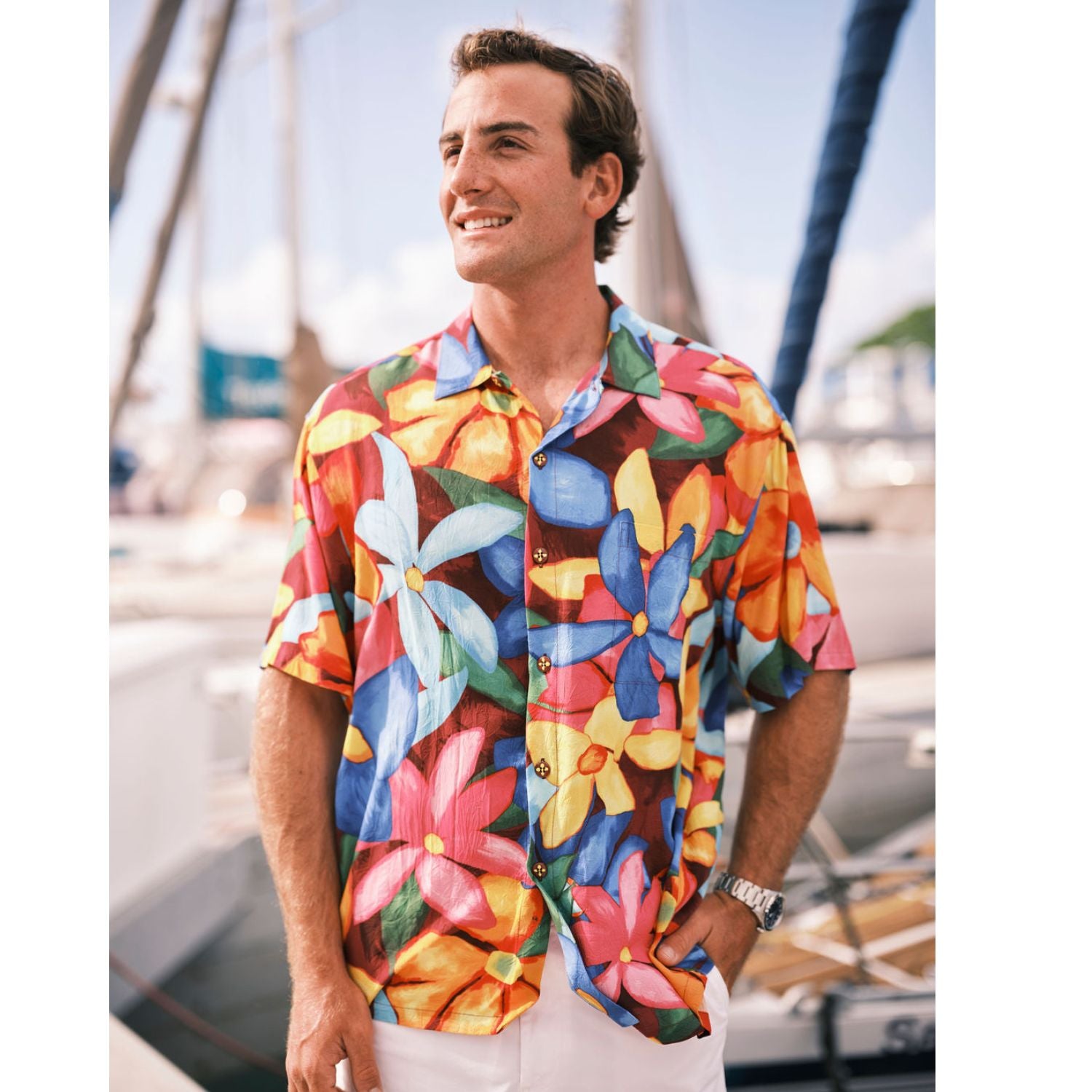 Man wearing a colorful floral shirt by a marina