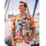 Man wearing a colorful floral shirt by a marina