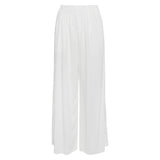 A product-only shot of a pair of full-length white wide-leg pants shown flat against a white background. The pants feature an elastic, gathered waistband and have a smooth, flowing drape to the fabric.