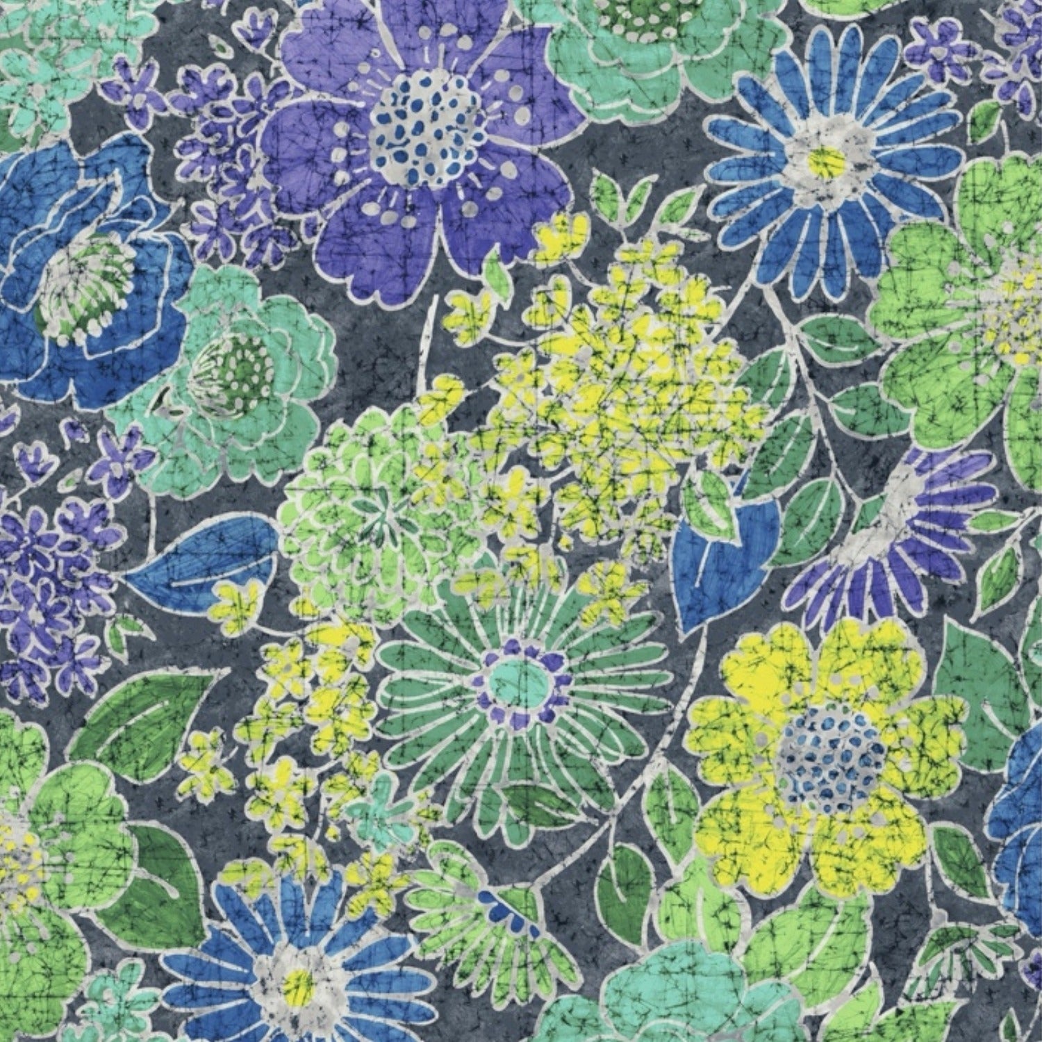 A detailed batik textile pattern featuring various hand-drawn flowers in shades of purple, turquoise, and lime green over a dark grey, crackled background.
