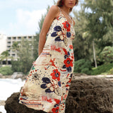Woman wearing a floral dress on a beach with trees and buildings in the background