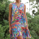 A sleeveless v-neck dress with a colorful, busy bohemian print and a tiered ruffle hem.