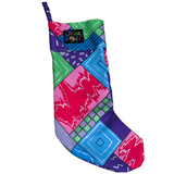 A single christmas stocking featuring a bold, colorful patchwork design of geometric shapes, including squares and diamonds. The colors include lime green, bright pink, red, turquoise, and various shades of purple, with silver metallic accents. A small black patch with the "Jams World" logo is visible on the green cuff.