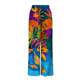 Colorful tropical-themed pants with fish design on a white background