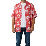 Person wearing a red floral patterned shirt on a white background