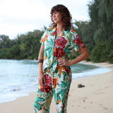 Woman wearing a colorful floral outfit on a beach