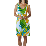 Woman wearing a colorful dress with abstract patterns on a white background