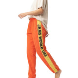Orange sweatpants with 'JAMS WORLD USA' stripe on a white background