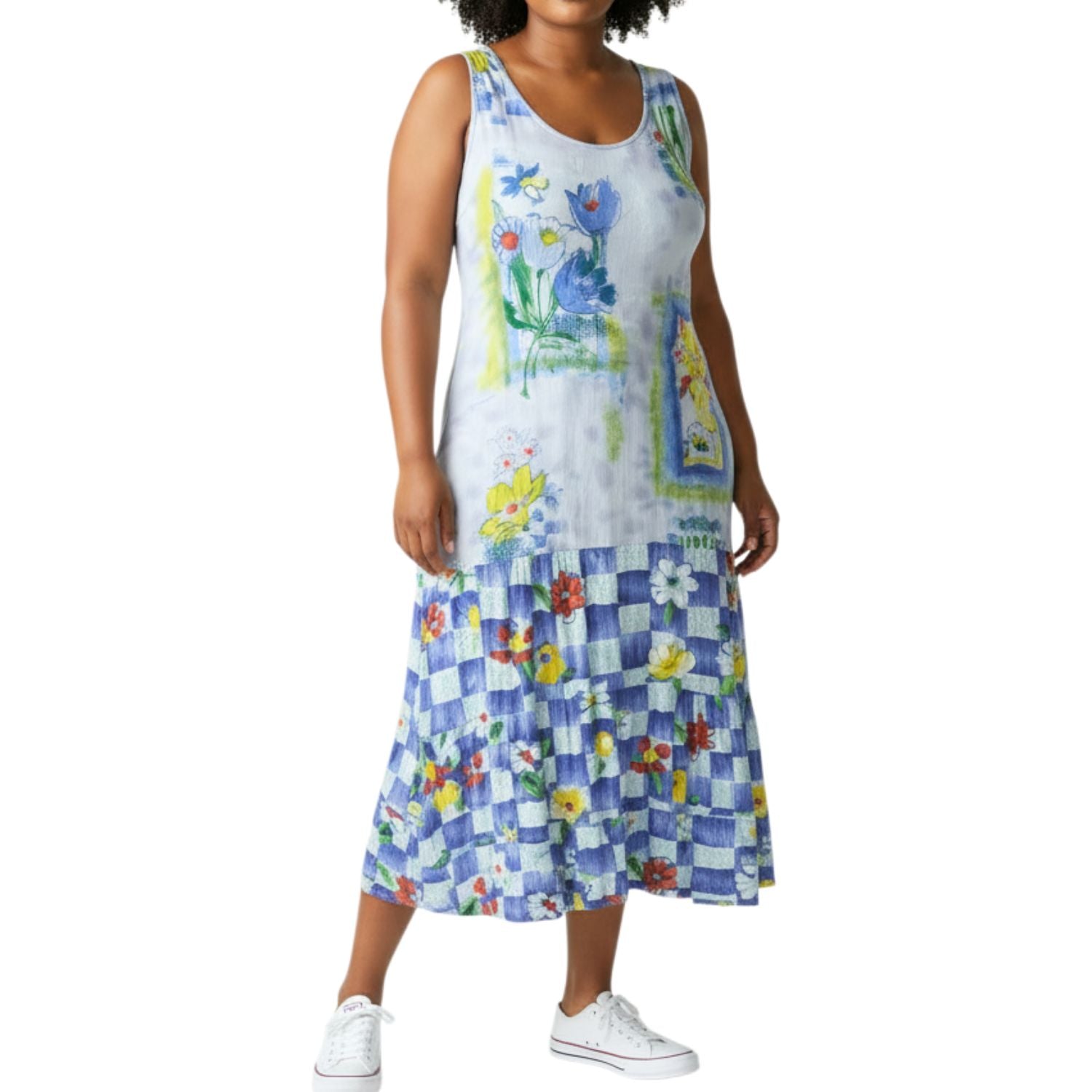 Woman wearing a colorful dress with floral and checkered patterns on a white background