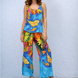 Person wearing a colorful outfit with fish patterns against a light blue background