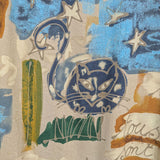 Textile with cat design and text on a textured background