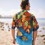 Man wearing a colorful tropical shirt on a beach