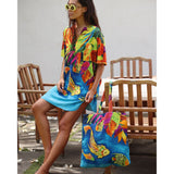 Woman in colorful dress holding a matching tote bag outdoors