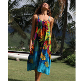 Woman wearing a colorful dress with a tropical pattern in a garden setting
