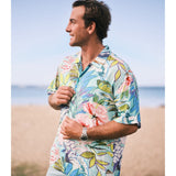 Man wearing a colorful floral shirt on a beach