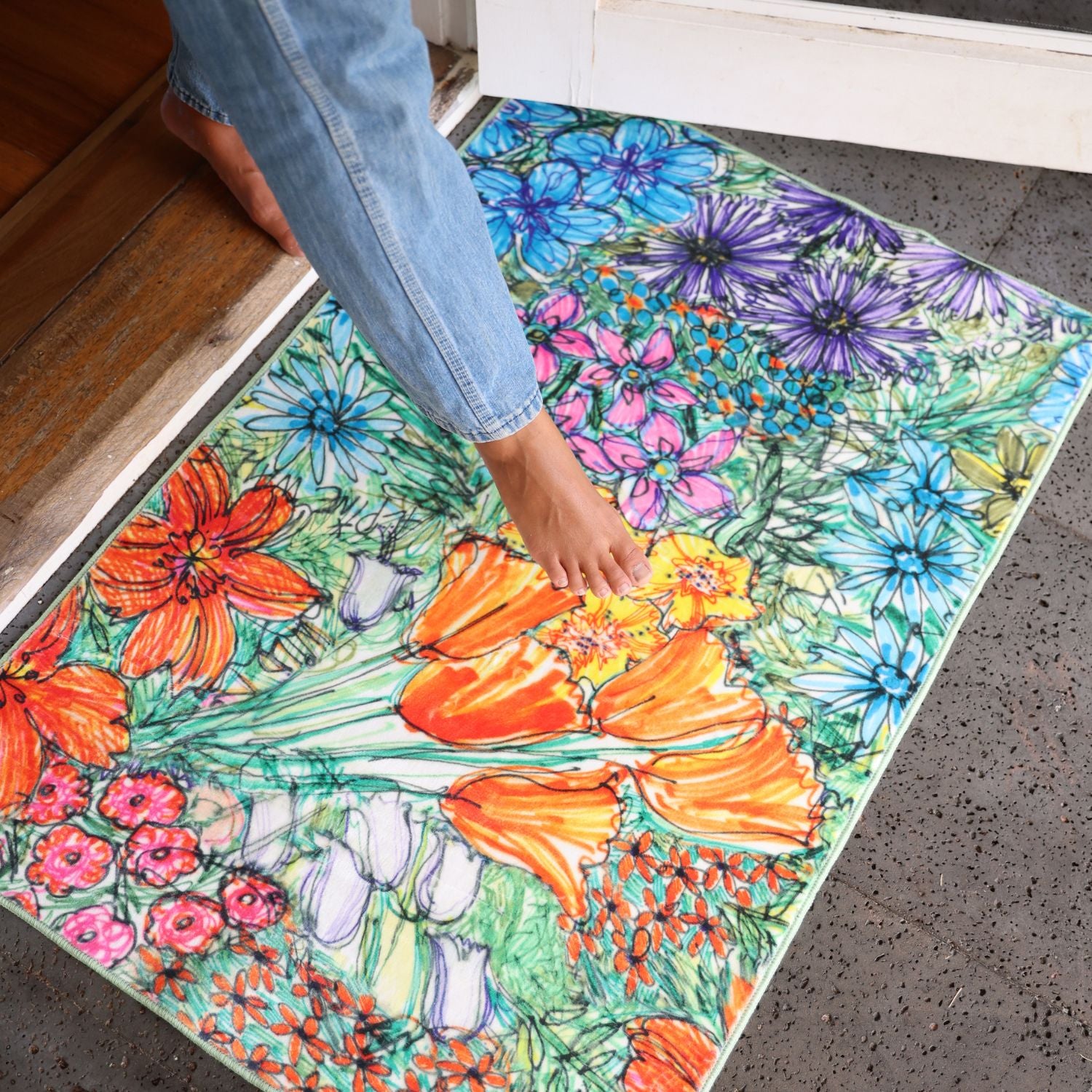 Colorful floral rug with a person stepping onto it