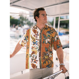 Man wearing a colorful floral shirt on a boat