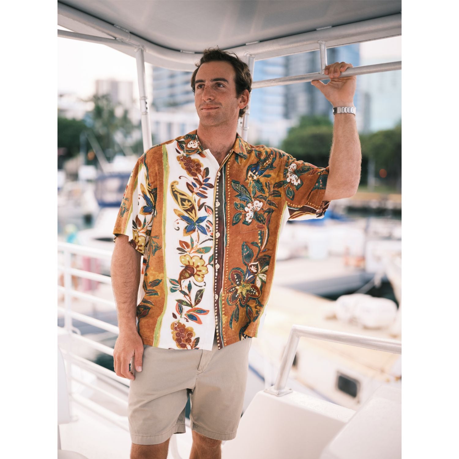 Man wearing a colorful floral shirt on a boat