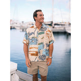 Man wearing a patterned shirt standing by a marina