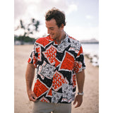 Man wearing a colorful patterned shirt on a beach