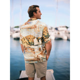 Scenic net fishing scene in the islands button down aloha shirt on model standing on pier.