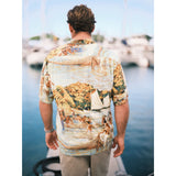 Scenic net fishing scene in the islands button down aloha shirt on model standing on pier.
