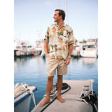 Scenic net fishing scene in the islands button down aloha shirt on model standing on pier.