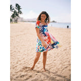 Colorful floral  circus flower doris dress on model standing on the beach