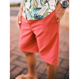 Model standing on walk way with solid red shorts