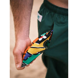 Green shorts with a colorful pocket pulled out.