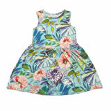 A sleeveless children's dress with a vibrant tropical floral print on a light blue background, featuring pink, purple, and green leaves and flowers, shown flat against a white background.