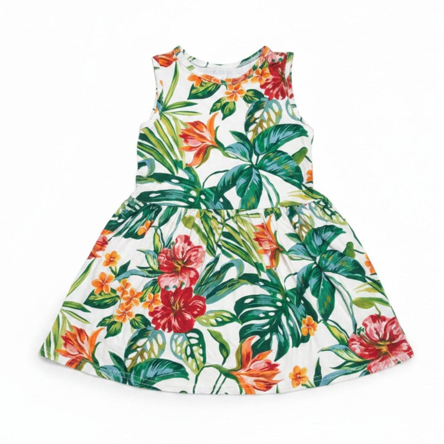 A sleeveless white dress with a vibrant tropical floral and leaf print, featuring red hibiscus, orange lilies, and green monstera and palm leaves, shown against a plain white background.