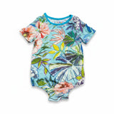 short-sleeved baby romper with a vibrant, colorful tropical floral pattern against a light blue background. 