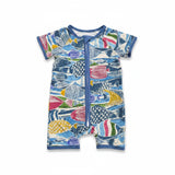 A short-sleeved, short-legged baby romper featuring an all-over vibrant pattern of illustrated fish in shades of blue, pink, yellow, and green, with a blue zipper running down the center.